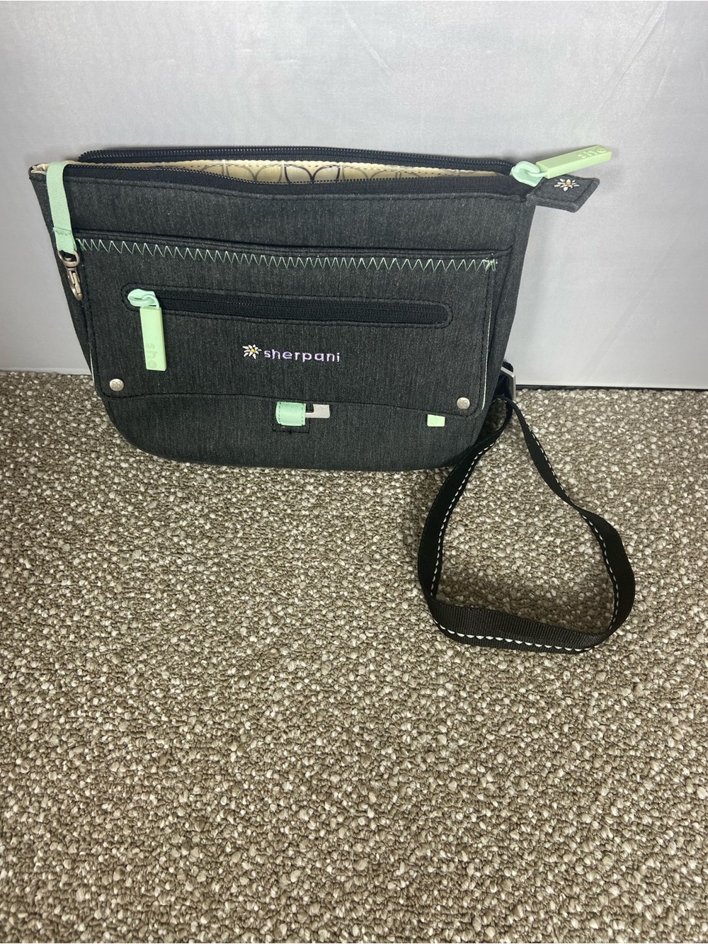Sherpani Black Crossbody with Mint Trim.Pre-Owned Little small stain,Like New.